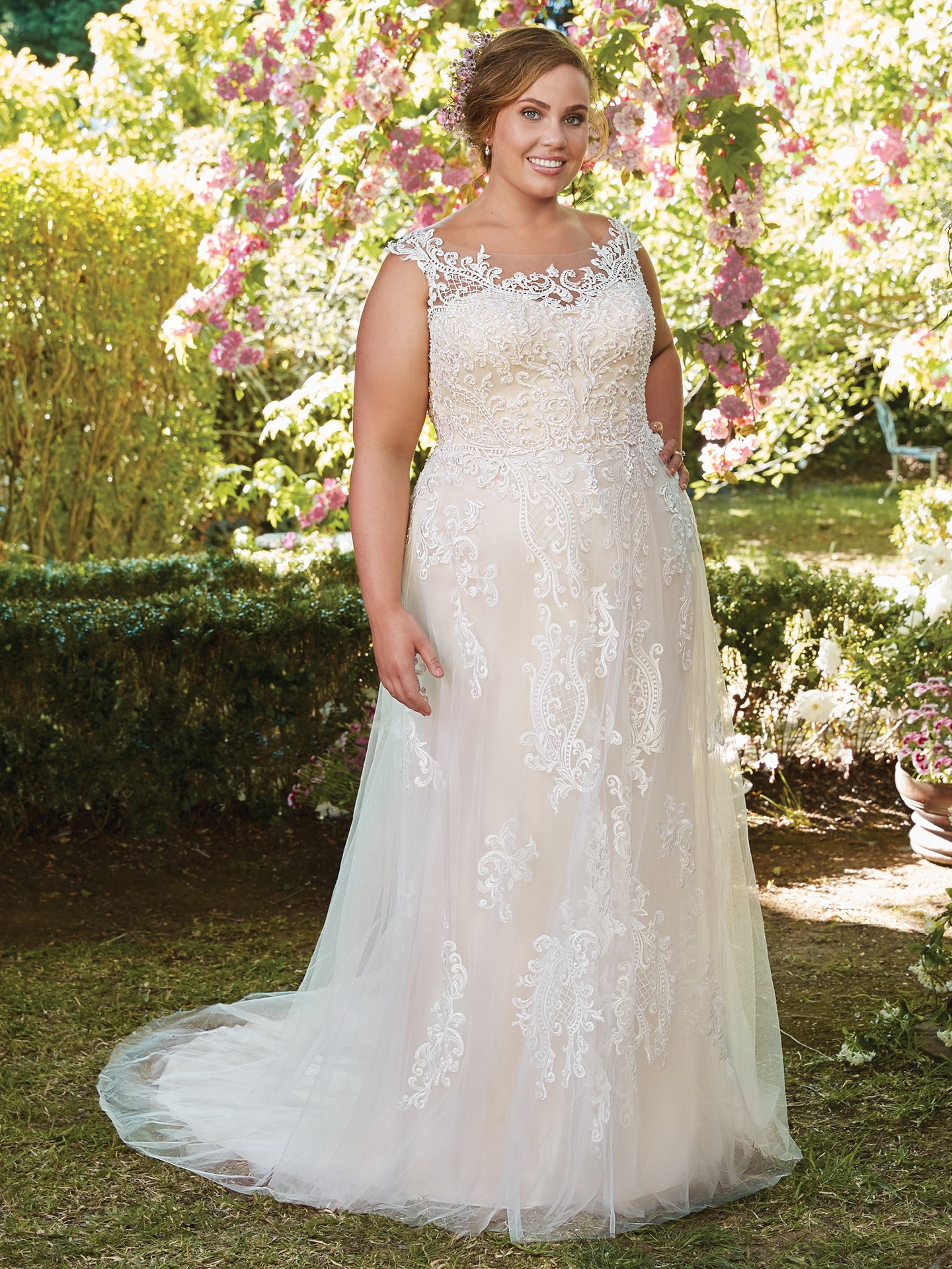 Alexis by Rebecca Ingram. This flirty A-line wedding gown features distinctive crosshatch motifs embellished with Swarovski crystals, delicate beading, and sequins. Illusion details accented in lace appliqués create beautiful back interest. Finished with covered buttons over zipper closure.