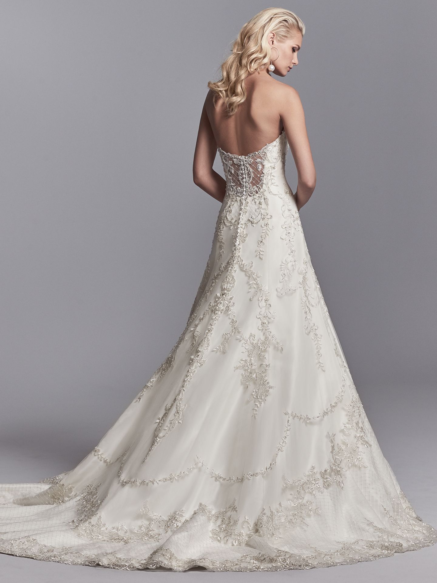 Granger by Sottero and Midgley. Embroidered lace motifs and Swarovski crystals dance over this tulle and Soft Shimmer Satin A-line wedding gown, featuring a strapless sweetheart neckline, illusion scoop back accented in beaded lace motifs, and crosshatch detail through the hemline. 10 Top-Pinned Sottero and Midgley Gowns of 2017.