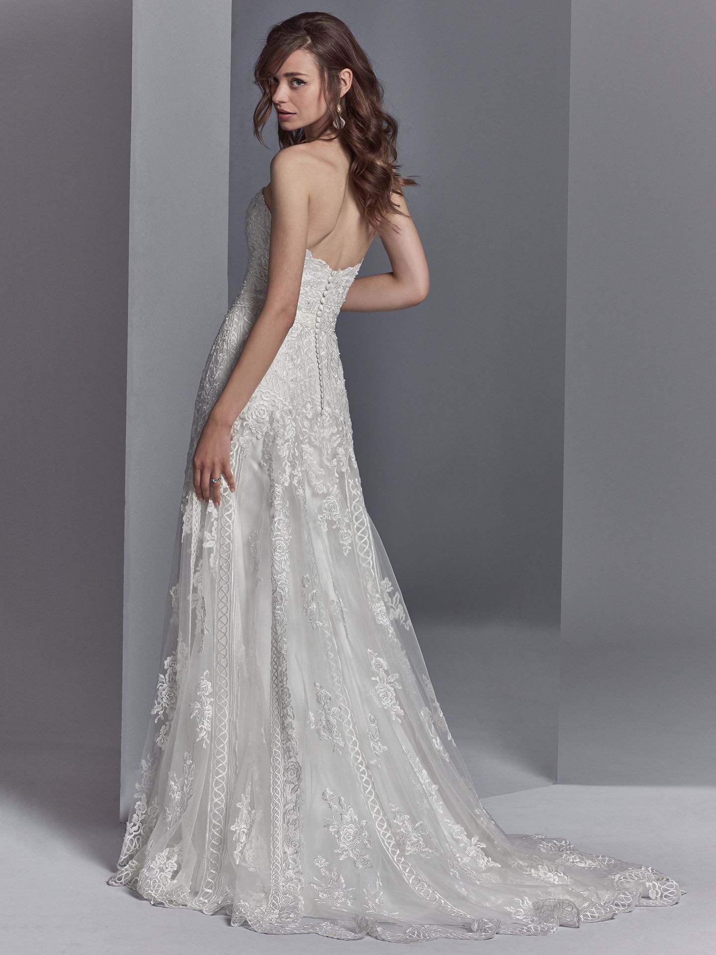 Skylar by Sottero and Midgley. Embroidered lace motifs accented in beading and Swarovski crystals cascade over tulle in this sheath wedding dress, completing the strapless sweetheart neckline and scallop lace hemline. 10 Top-Pinned Sottero and Midgley Gowns of 2017.